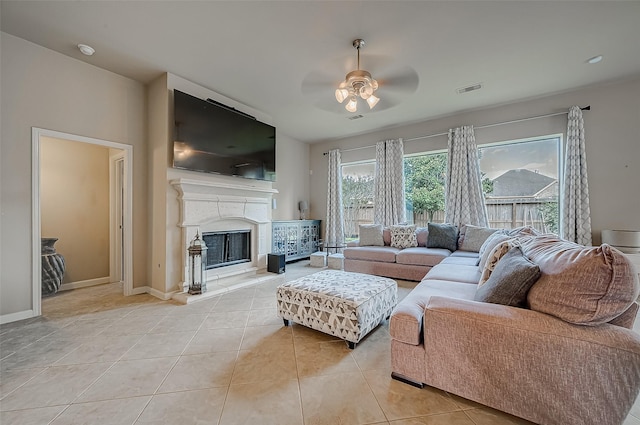 living room with ceiling fan and light tile patterned flooring