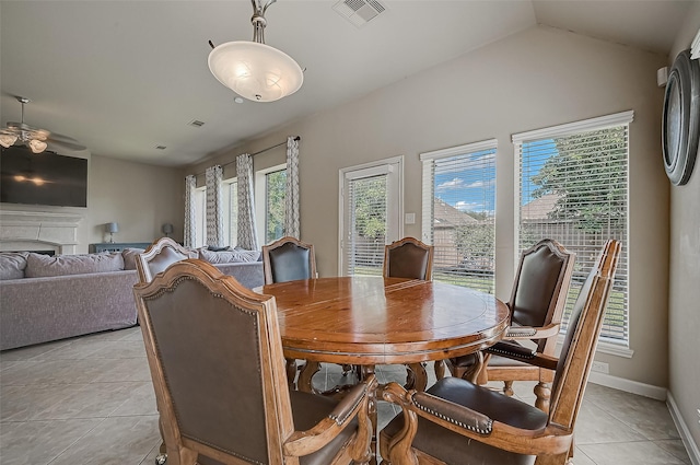 tiled dining area with vaulted ceiling