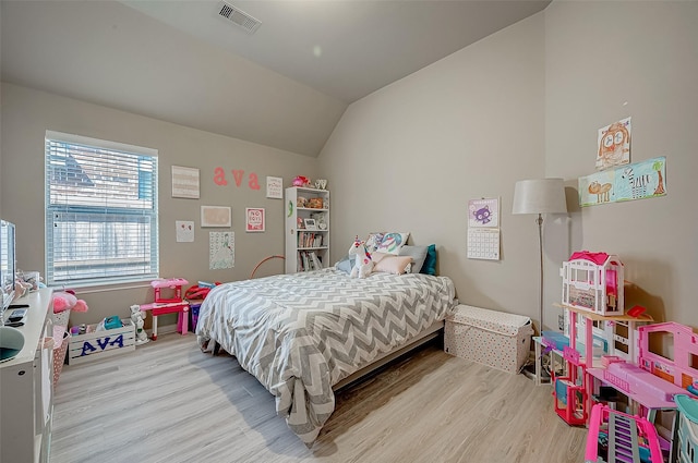 bedroom featuring vaulted ceiling and light wood-type flooring