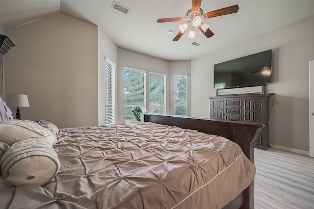 bedroom featuring ceiling fan, light wood-type flooring, and lofted ceiling