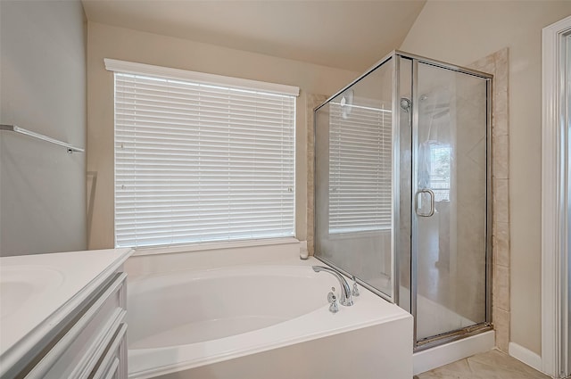 bathroom featuring plus walk in shower, vanity, and a healthy amount of sunlight