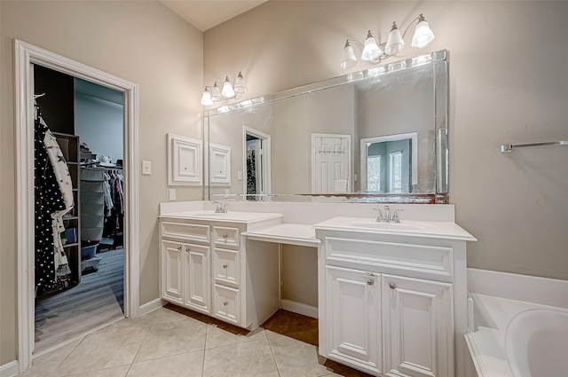 bathroom with tile patterned floors, vanity, and a bath