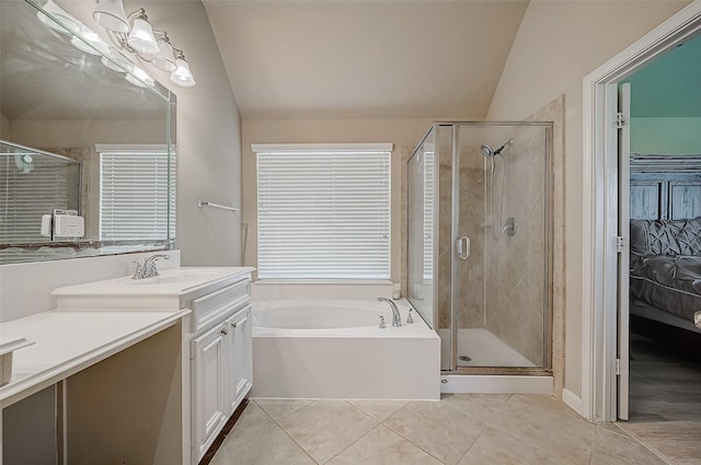 bathroom with tile patterned flooring, vanity, separate shower and tub, and lofted ceiling