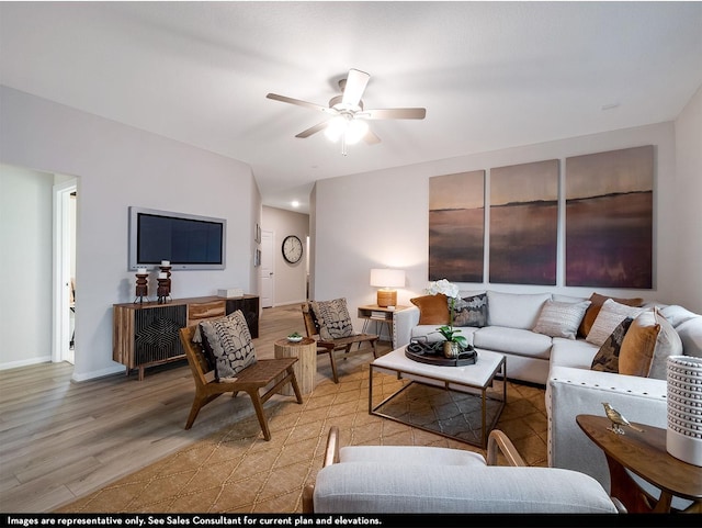 living room featuring light hardwood / wood-style floors and ceiling fan