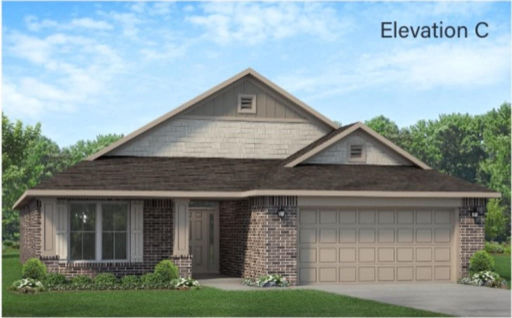 view of front of home featuring a front lawn and a garage