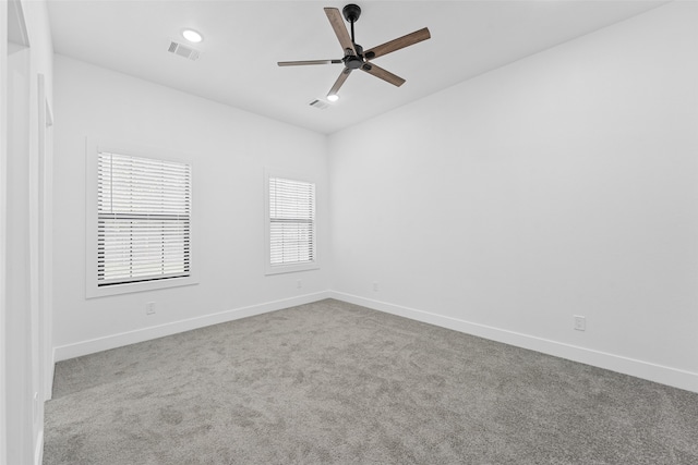 carpeted spare room featuring ceiling fan