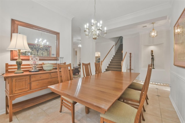 tiled dining area with crown molding and an inviting chandelier