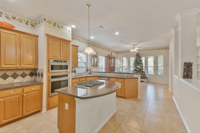 kitchen with light tile patterned floors, decorative light fixtures, a center island, and kitchen peninsula