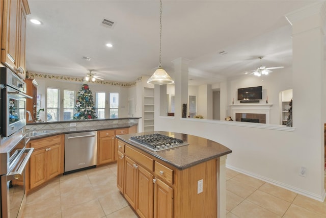 kitchen with pendant lighting, appliances with stainless steel finishes, kitchen peninsula, and light tile patterned flooring