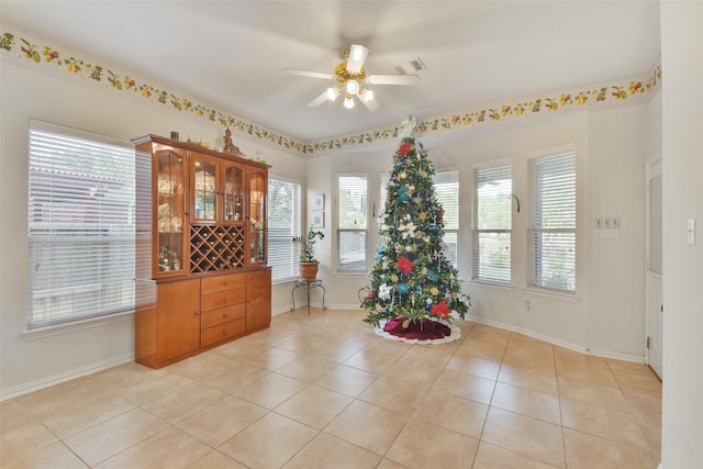 interior space with light tile patterned flooring and ceiling fan