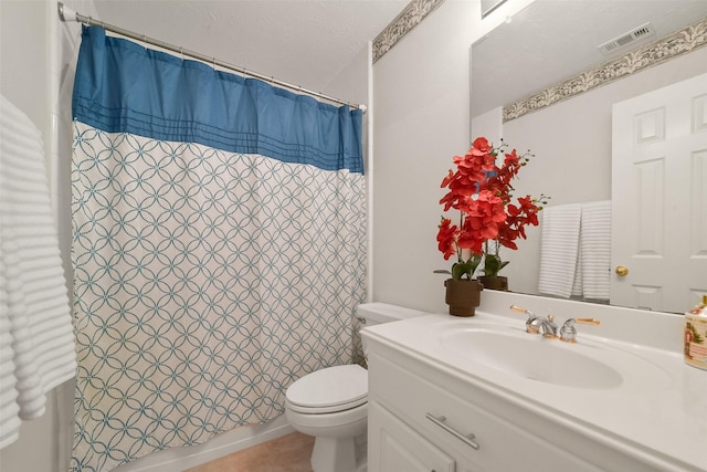 full bathroom with vanity, shower / tub combo with curtain, a textured ceiling, and toilet