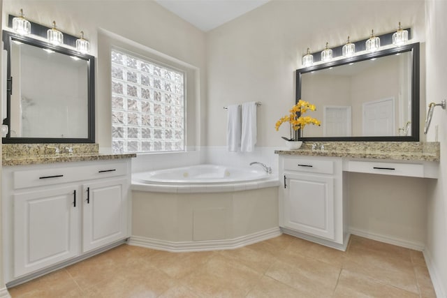 bathroom featuring vanity, tile patterned floors, and a tub