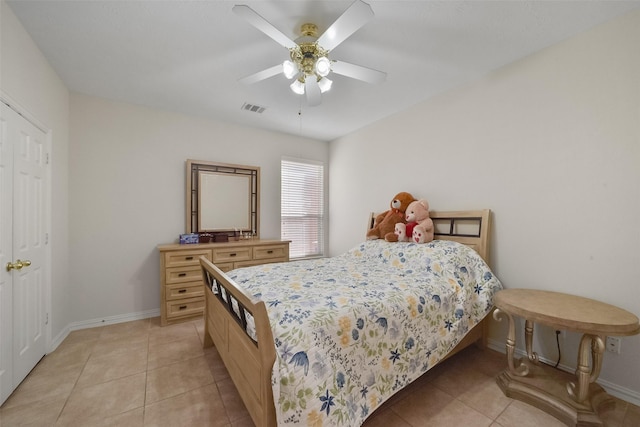 tiled bedroom featuring ceiling fan