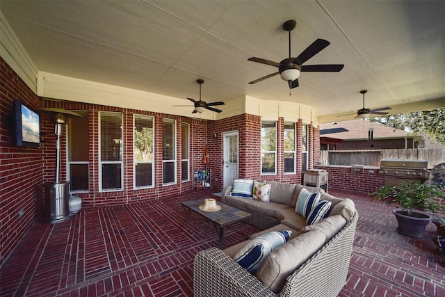 view of patio featuring area for grilling, an outdoor living space, a grill, and ceiling fan