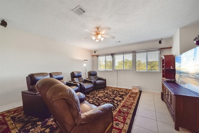 tiled living room featuring ceiling fan and a textured ceiling