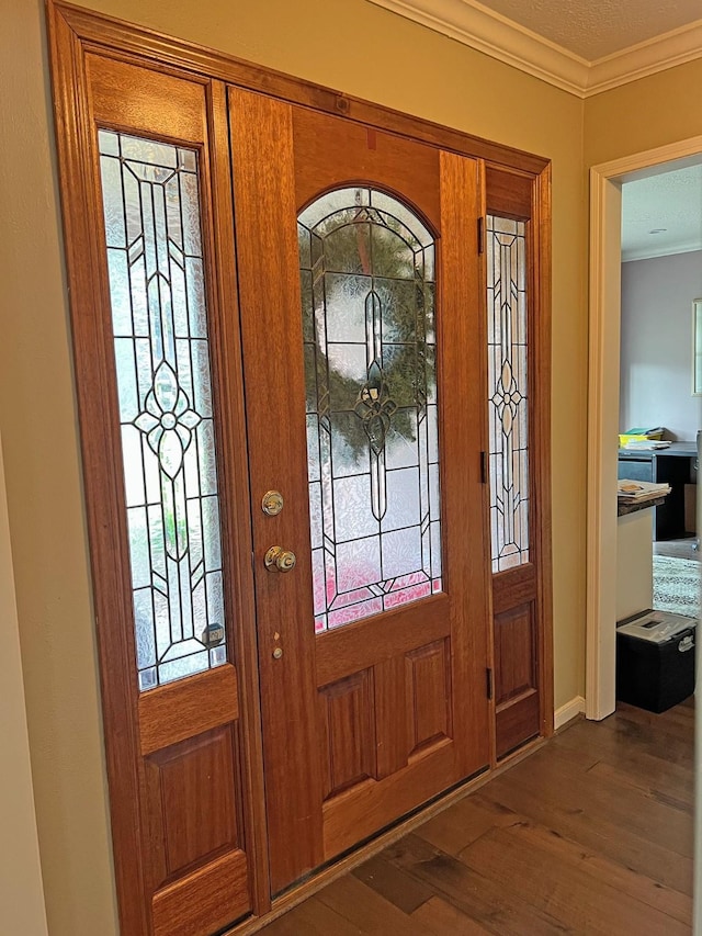 entrance foyer featuring a textured ceiling, crown molding, and dark hardwood / wood-style floors