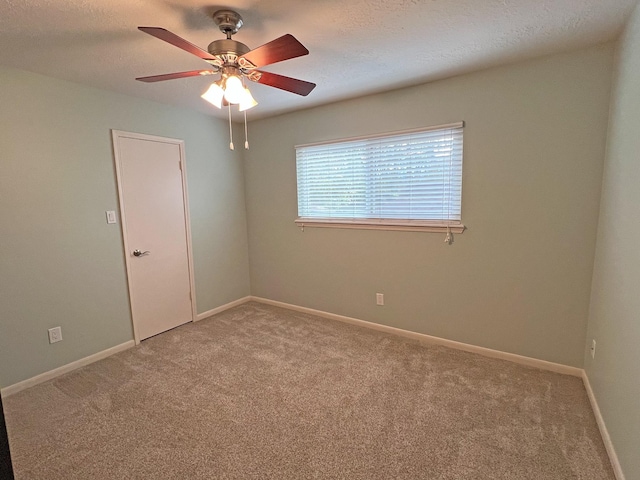 unfurnished room with a textured ceiling, carpet floors, and ceiling fan