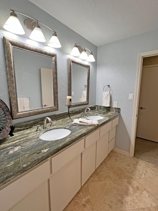 bathroom with vanity and a textured ceiling