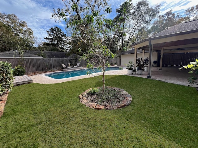 view of pool featuring a lawn and a patio area