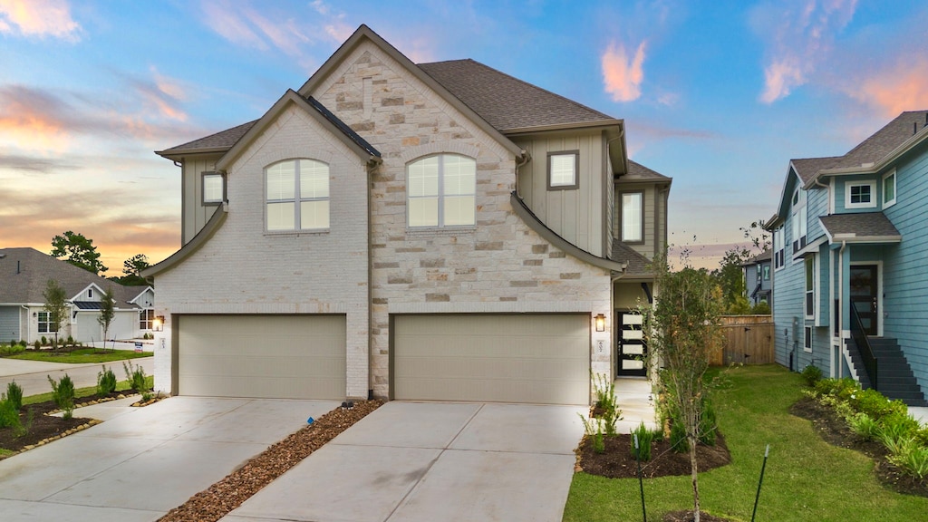 view of front of property featuring a lawn and a garage