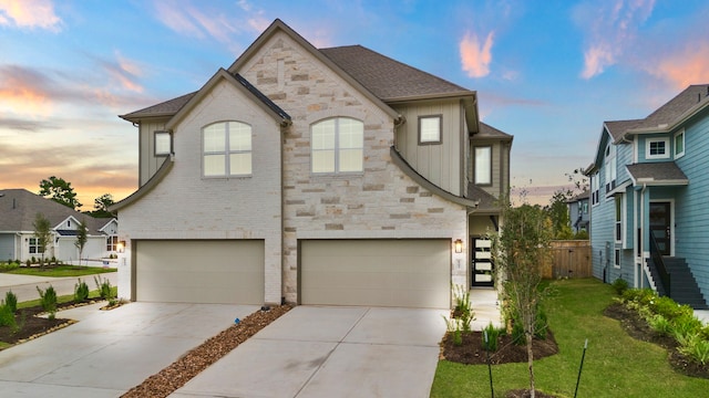 view of front of property featuring a lawn and a garage