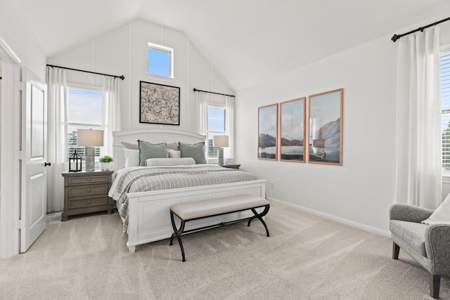 carpeted bedroom featuring multiple windows and lofted ceiling