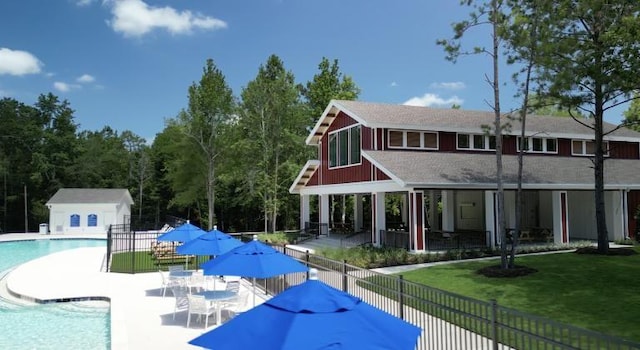 exterior space with a patio area, a yard, and an outdoor structure