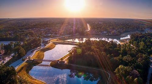 aerial view at dusk featuring a water view