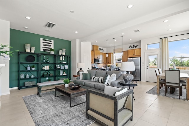 living room featuring plenty of natural light and light tile patterned floors