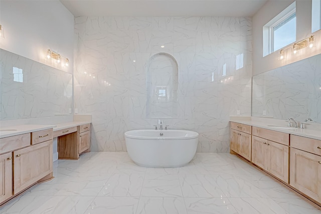 bathroom with tile walls, vanity, and a bathing tub