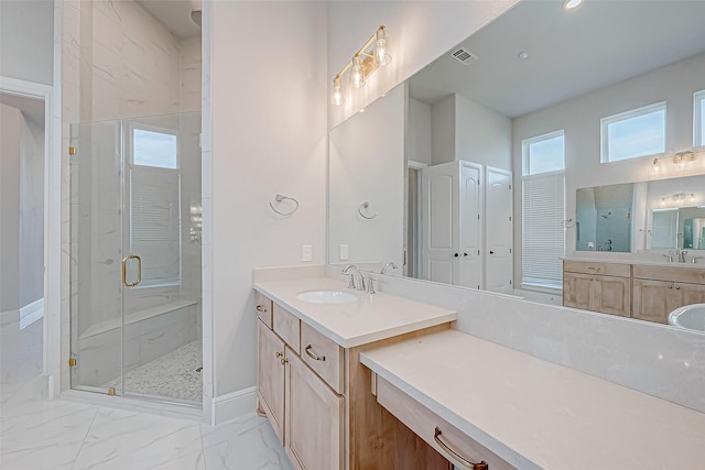 bathroom featuring walk in shower and vanity