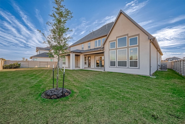 back of property featuring a patio area and a yard