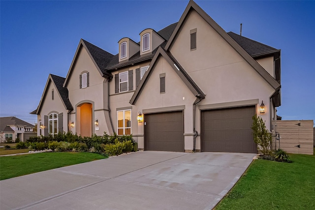 view of front of home with a garage and a front lawn