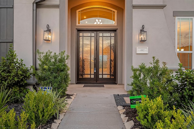 view of exterior entry featuring french doors