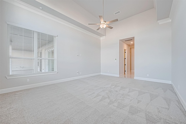 unfurnished room with light carpet, ceiling fan, crown molding, and high vaulted ceiling