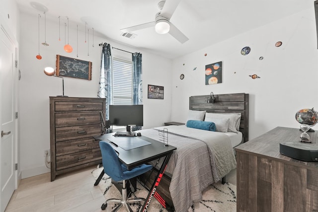 bedroom with light hardwood / wood-style floors and ceiling fan