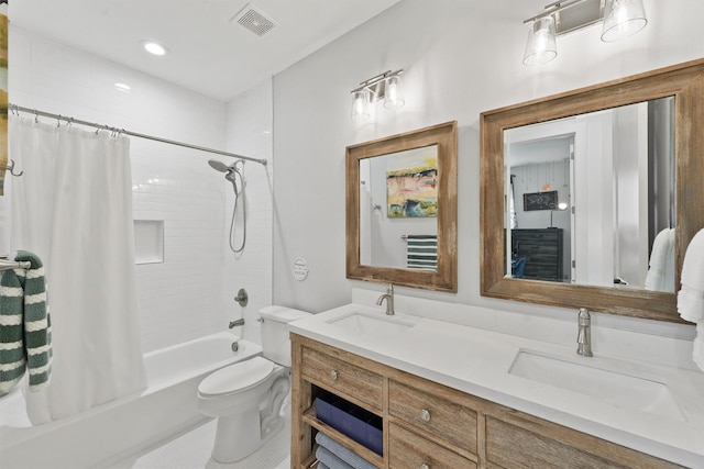 full bathroom featuring tile patterned flooring, shower / bath combo with shower curtain, vanity, and toilet