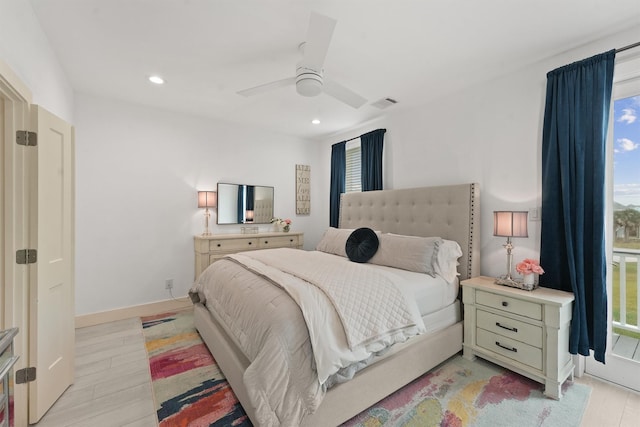 bedroom featuring multiple windows, ceiling fan, and light hardwood / wood-style floors