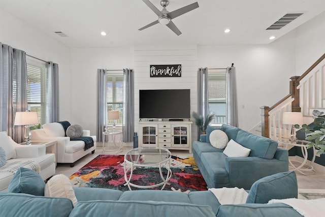 living room featuring ceiling fan and a healthy amount of sunlight