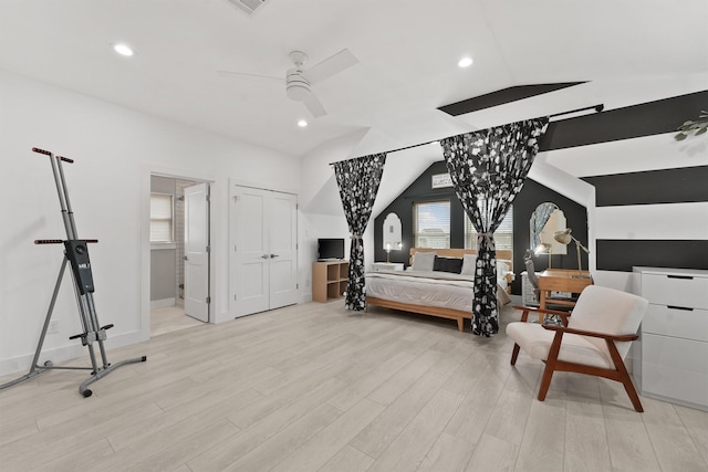 bedroom featuring connected bathroom, ceiling fan, lofted ceiling, and light wood-type flooring