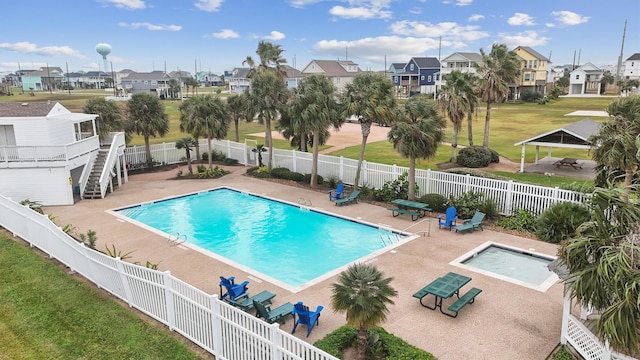 view of swimming pool with a lawn