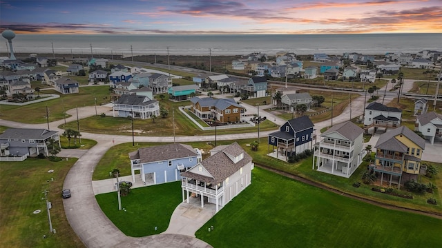 aerial view at dusk with a water view