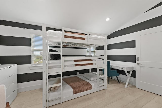 bedroom with light hardwood / wood-style floors and vaulted ceiling