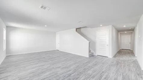 355 E Northpointe Ave, La Grange, TX 78945 - below grade area with wood finished floors, recessed lighting, baseboards, and stairway