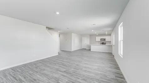 355 E Northpointe Ave, La Grange, TX 78945 - unfurnished living room with baseboards, wood finished floors, and recessed lighting