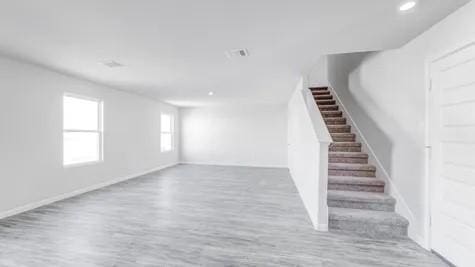 355 E Northpointe Ave, La Grange, TX 78945 - basement with wood finished floors, stairs, recessed lighting, and baseboards