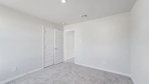 unfurnished room with light colored carpet