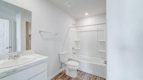355 E Northpointe Ave, La Grange, TX 78945 - bathroom featuring toilet, vanity, washtub / shower combination, and wood finished floors
