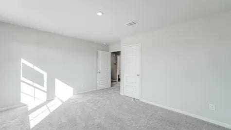 unfurnished room featuring light carpet