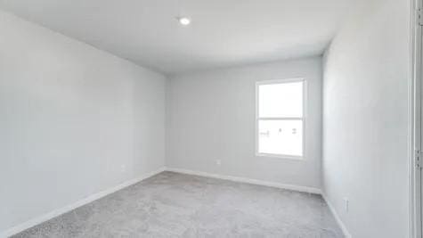 unfurnished room with light colored carpet